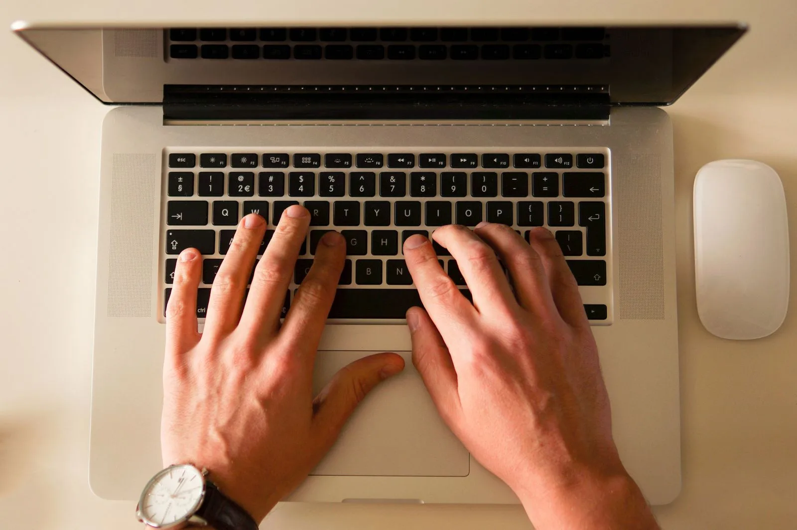 Writer typing and editing professional correspondence on laptop computer
