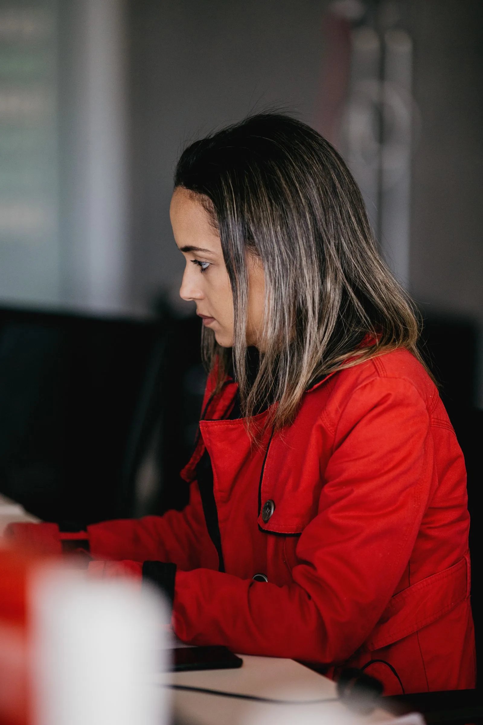 Marketing coordinator tailoring applications at computer