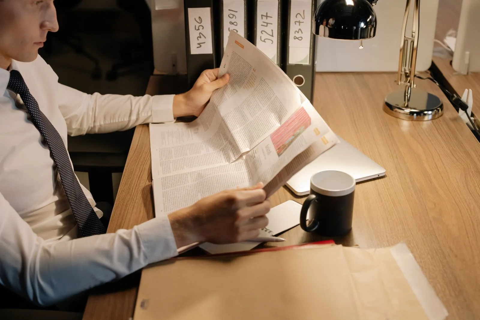 A professional carefully reviewing a document or paper