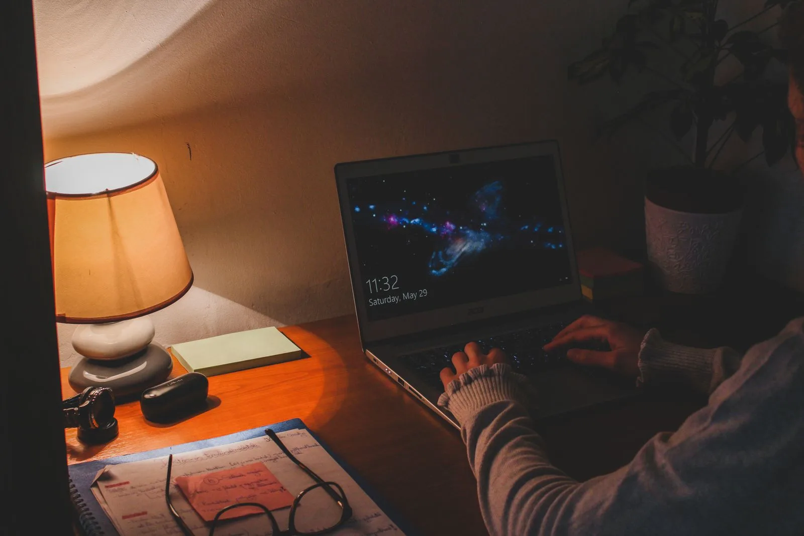 Tired professional working intently at computer late into evening