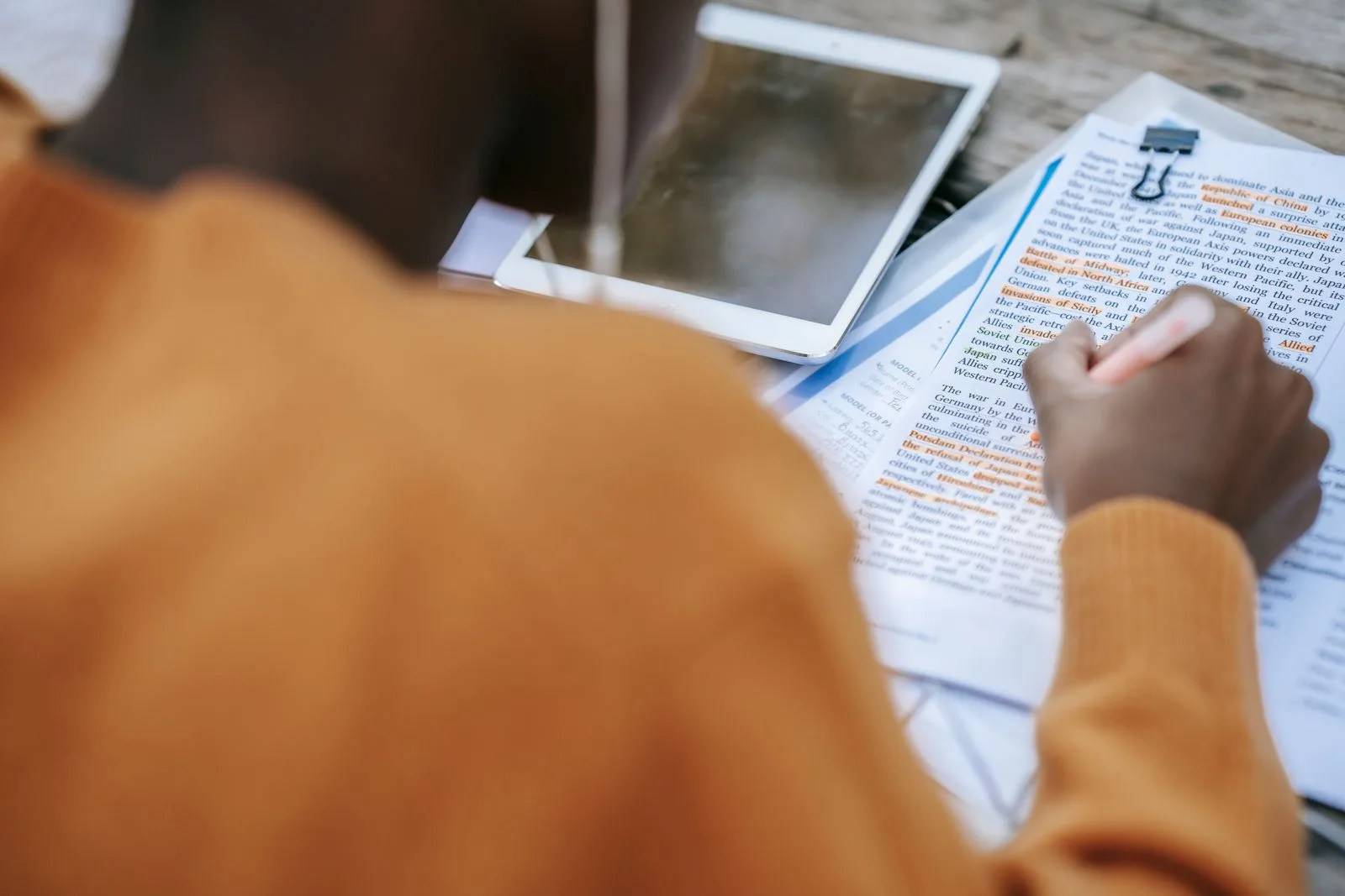 Professional writing notes while researching company and job details