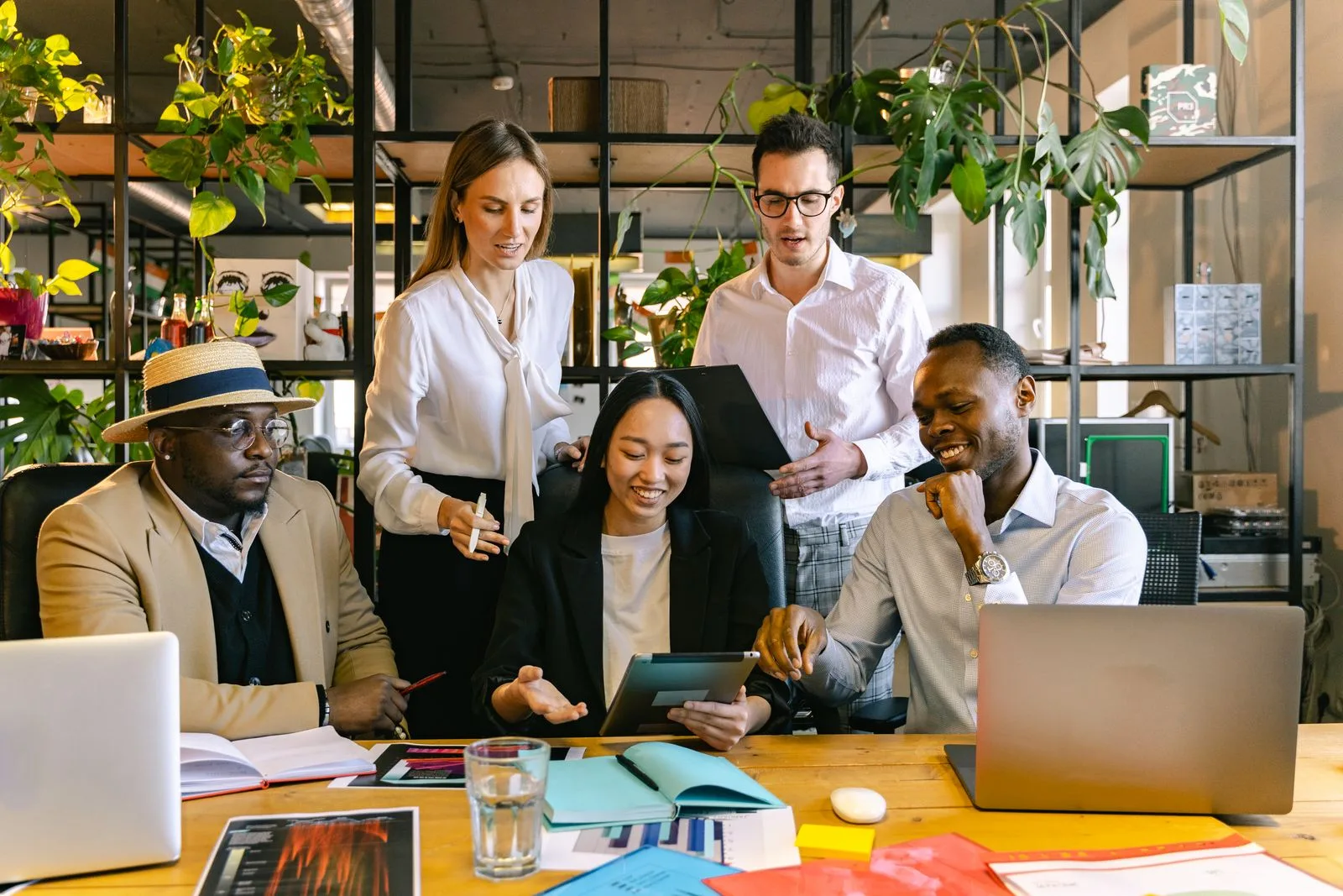 A recruitment team collaborating in an office environment while managing applications