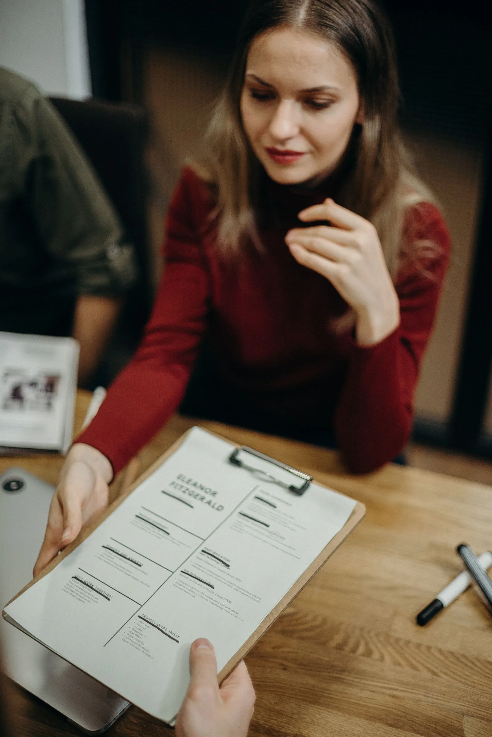 Job seeker drafting professional resume with metrics and achievements