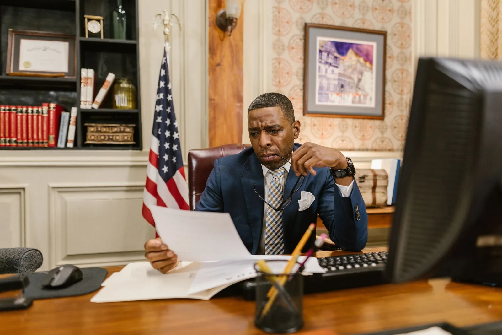 Government office professional reviewing job application materials