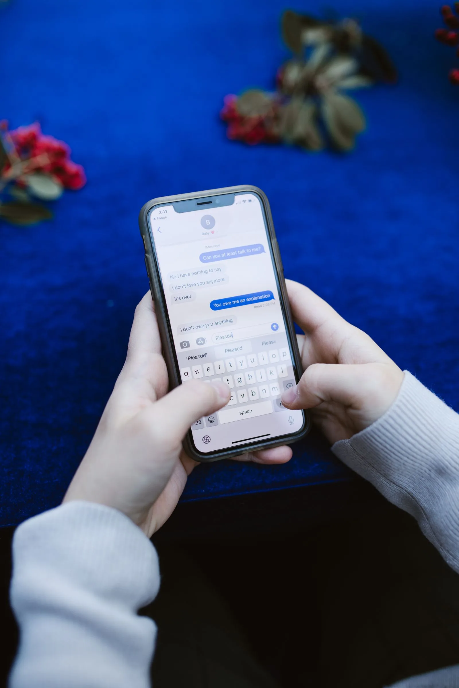 Person carefully examining a text message on their phone