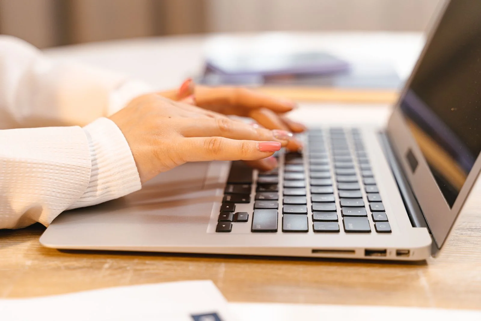 Job seeker writing detailed resume accomplishments on laptop