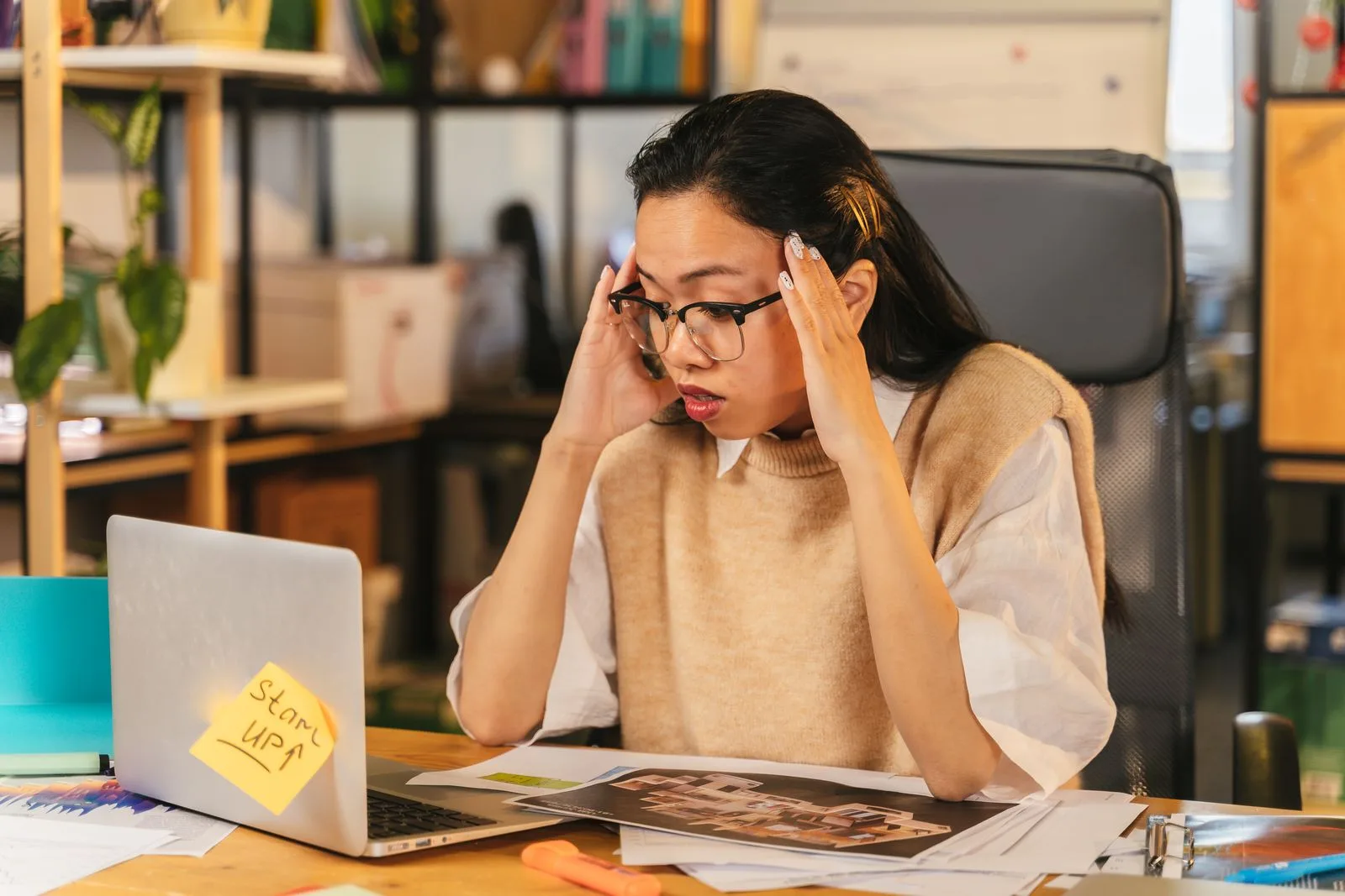 Frustrated professional at desk overwhelmed by resume work